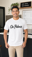 Oo Paleez white graphic tee worn by male model in cafe setting